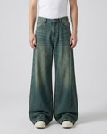 Big Easy baggy jeans in vintage blue on model — mega baggy fit, hem stacked over sneakers