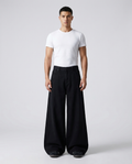 Session baggy jeans in jet black on model — mega baggy fit covering sneakers