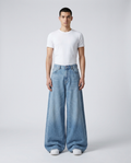 Big Easy baggy jeans in light blue on model — ultra wide leg stacked over shoes