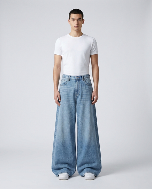 Big Easy baggy jeans in light blue on model — ultra wide leg stacked over shoes