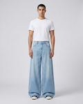 Boulevard wide leg jeans in washed blue on model — hem draping over shoes