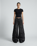 Women's cargo baggy jeans in jet black on model — mega baggy fit