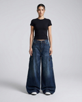 Women's cargo baggy jeans in washed blue on model — wide leg pooling over shoes