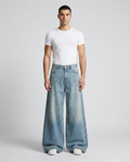 Slack Loose Fit Jeans Distressed Blue on model — mega baggy fit covering sneakers