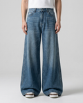 Slack Loose Fit Jeans Three-Bar Retro on model — mega baggy fit covering sneakers
