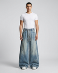 Slack Cargo Jeans Faded Blue on model — mega baggy fit covering sneakers