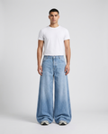 Big Easy Baggy Jeans Pale Indigo on model — mega baggy fit covering sneakers