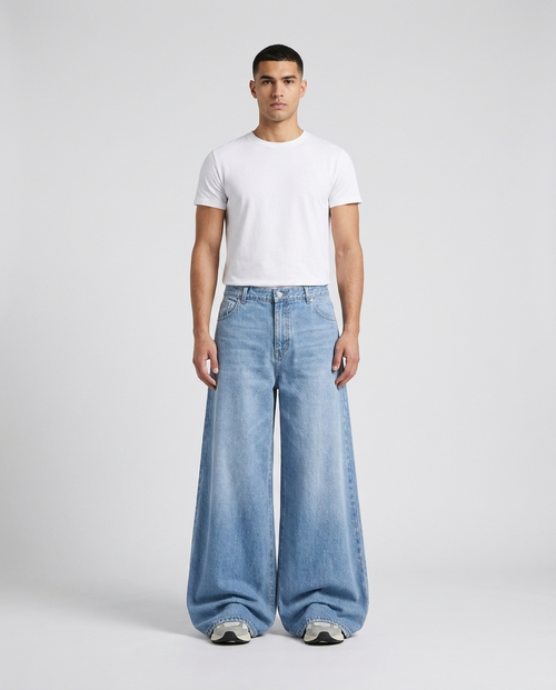 Big Easy Baggy Jeans Pale Indigo on model — mega baggy fit covering sneakers