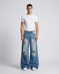 Slack Ripped Jeans — Faded Royal on model — mega baggy fit covering sneakers