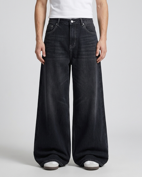 Big Easy Jeans Patchwork Night on model — mega baggy fit covering sneakers