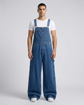 Foreman Overall Jeans Indigo Bib on model — mega baggy fit covering sneakers