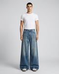Maxout Jeans Vintage Fade on model — mega baggy fit covering sneakers