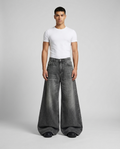 Big Easy Jeans Camo Star on model — mega baggy fit covering sneakers