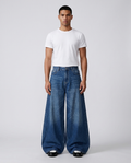 Maxout Jeans Rivet Blue on model — mega baggy fit covering sneakers