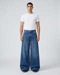 Maxout Jeans Stonewash on model — mega baggy fit covering sneakers