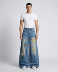 Maxout Embroidered Jeans Flora Blue on model — mega baggy fit covering sneakers