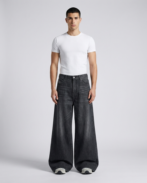 Big Easy Embroidered Jeans Wing Wash on model — mega baggy fit covering sneakers