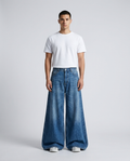 Maxout Jeans Ripple Fade on model — mega baggy fit covering sneakers