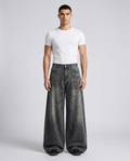 Slack Jeans Pewter on model — mega baggy fit covering sneakers