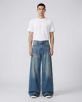 Maxout Jeans Campus Fade on model — mega baggy fit covering sneakers