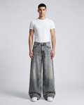 Maxout Jeans Snowflake Wash on model — mega baggy fit covering sneakers