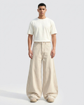 Slack Jeans Oat on model — mega baggy fit covering sneakers