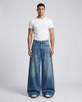Maxout Jeans Daybreak Fade on model — mega baggy fit covering sneakers