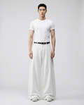 Cooper Jeans Ivory Wash on model — mega baggy fit covering sneakers