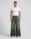 Maxout Jeans Seam Fade on model — mega baggy fit covering sneakers