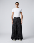 Maxout Jeans Paisley Night on model — mega baggy fit covering sneakers