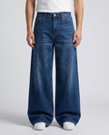 Slack Jeans Poster Fade on model — mega baggy fit covering sneakers