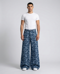 Maxout Jeans Feather Weave on model — mega baggy fit covering sneakers