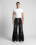 Session Ripped Jeans Static Stripe on model — mega baggy fit covering sneakers