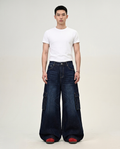 Foreman Jeans Switchback on model — mega baggy fit covering sneakers